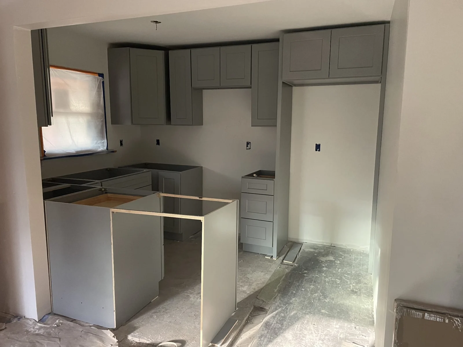 Stonehaus kitchen during renovation, with gray cabinets installed before countertops